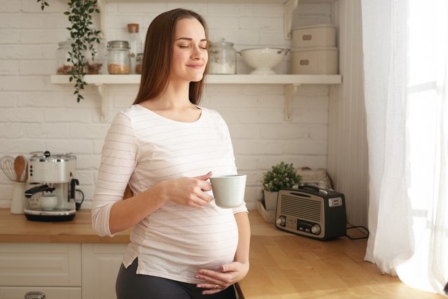 Mujer embarazada bebiendo té de jengibre
