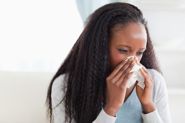 Woman blowing her nose